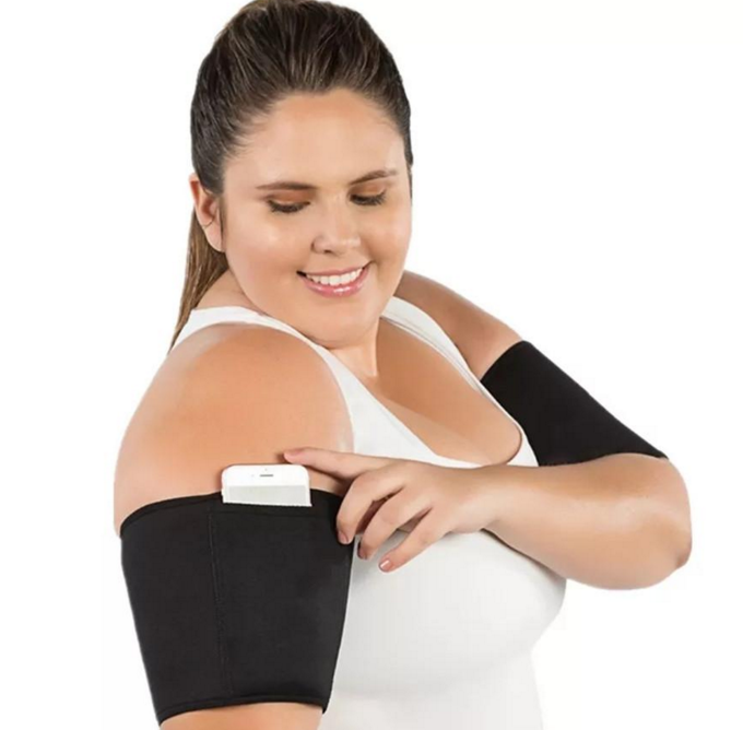 Black arm compression sleeve with white tab/attachment at the top edge.