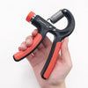 Adjustable hand gripper tool in orange and black, held in a hand