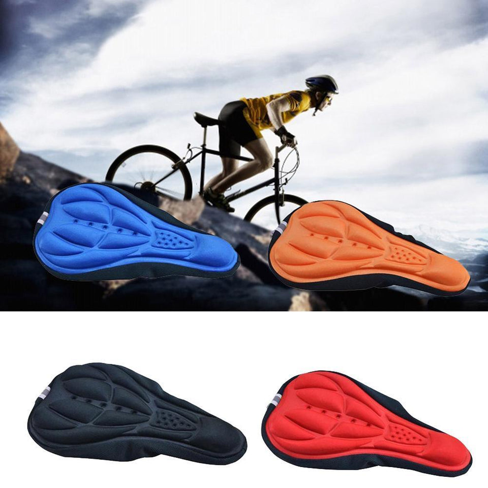Bike seat cushion covers in blue, orange, and black on a rugged surface