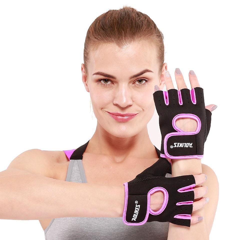 Black half-finger gym gloves with pink trim and hook-and-loop wrist, open fingertips