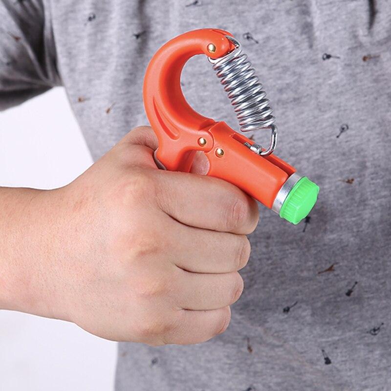 Adjustable hand gripper tool with orange body and green end cap, held in hand