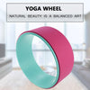 Pink and teal yoga wheel ring with textured surface and teal inner edge