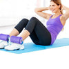 Purple foam suction bar with dual rollers used on a workout mat