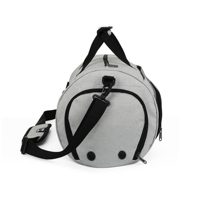 Light gray duffel bag with front zipper pocket, curved end panels, and black shoulder strap.