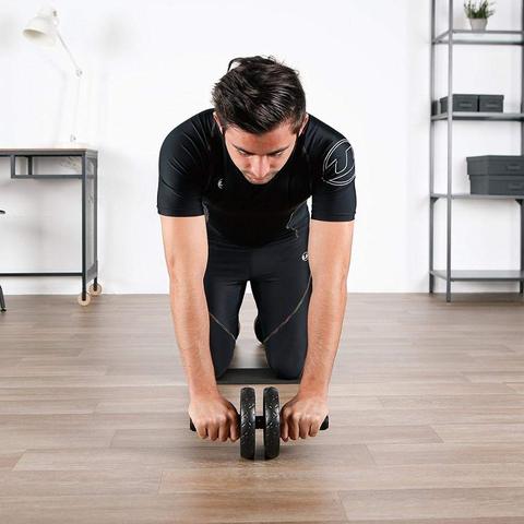Ab roller trainer used in kneeling rollout, showing two wheels and center grip