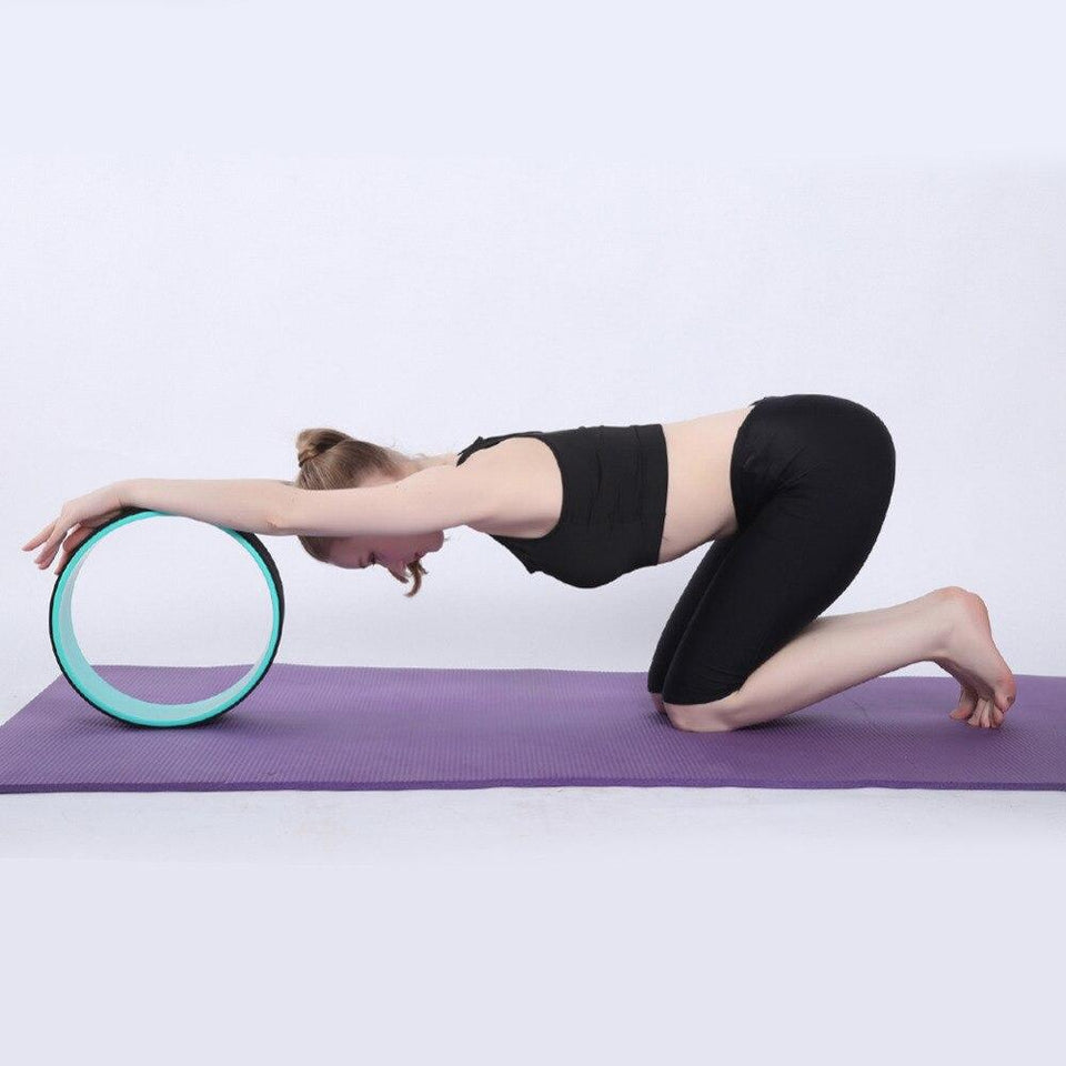Teal-rim yoga wheel ring under a forearm hip extension pose