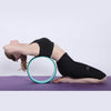 Teal-rim yoga wheel ring under a forearm plank pose