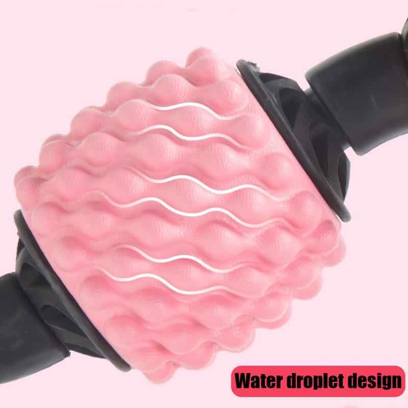 Pink spiked massage wheel with dark handle grips, close-up detail