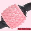 Pink spiked massage wheel with dark handle grips, close-up detail