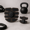 Abdominal muscle stimulator pad set with central controller, black with orange trim