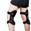 Black knee support pads with adjustable straps and metal spring hinges