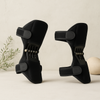 Black knee support pads with adjustable straps and spring mechanisms, set of two
