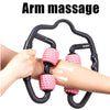 U-shape arm massage roller with pink spiked wheels on black frame, in use on arm