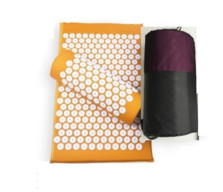 Orange acupressure yoga mat with white circular spike pads and a purple pouch