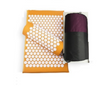 Orange acupressure yoga mat with white circular spike pads and a purple pouch