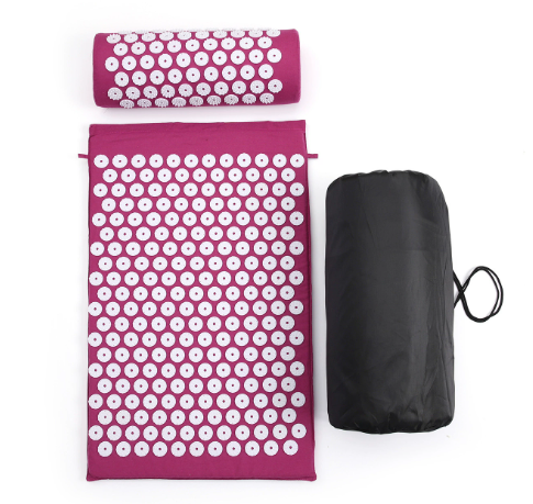 Acupressure yoga mat and massage cushion set in magenta with white button pads and carry bag
