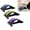 Massage stretcher with blue, green, and purple padded arches on a black base