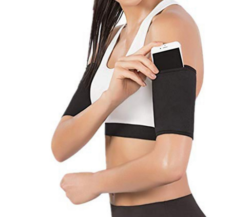 Black arm compression sleeve with pocket holding a smartphone at the upper arm.